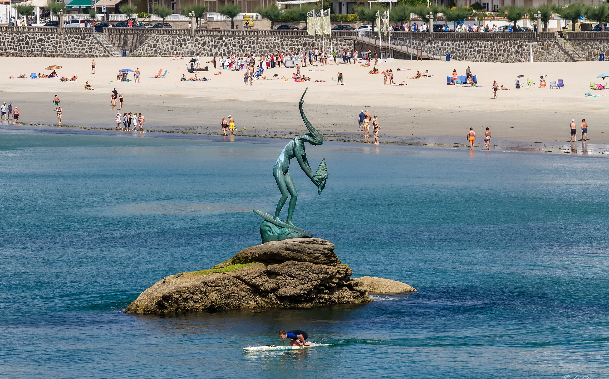 Foto de la Playa de Silgar en la que se puede ver la escultura de Madame Silgar encima de una piedra que sale del mar.
